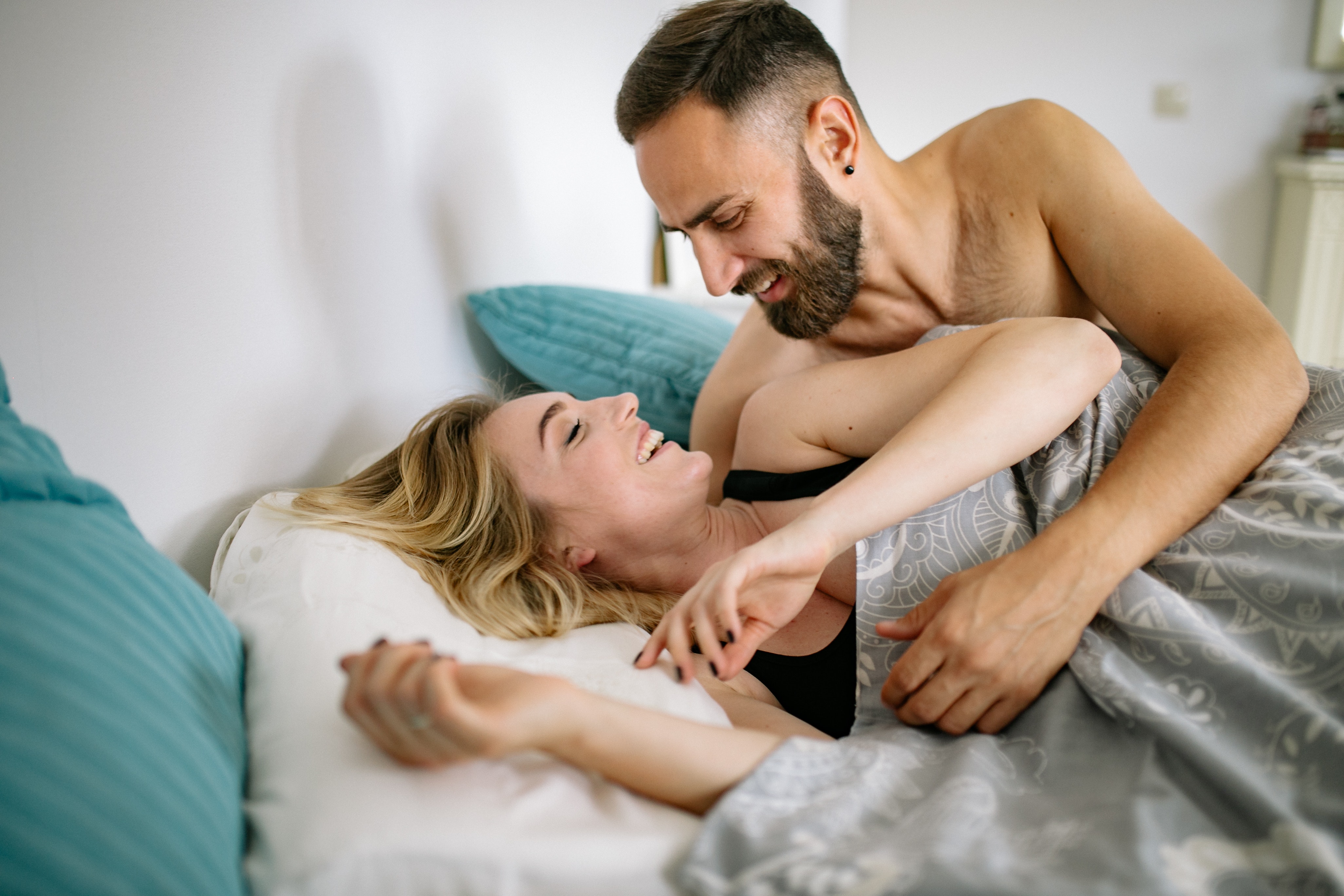 An image of a couple embracing and smiling.